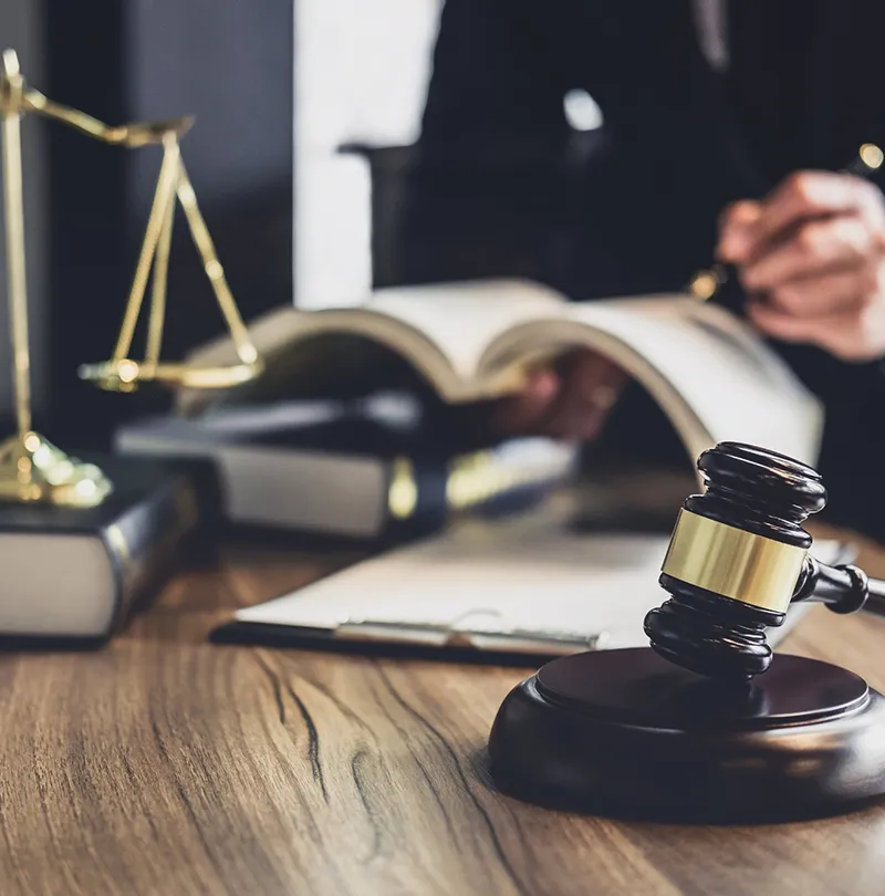 A judge 's desk with gavel and scale of justice.