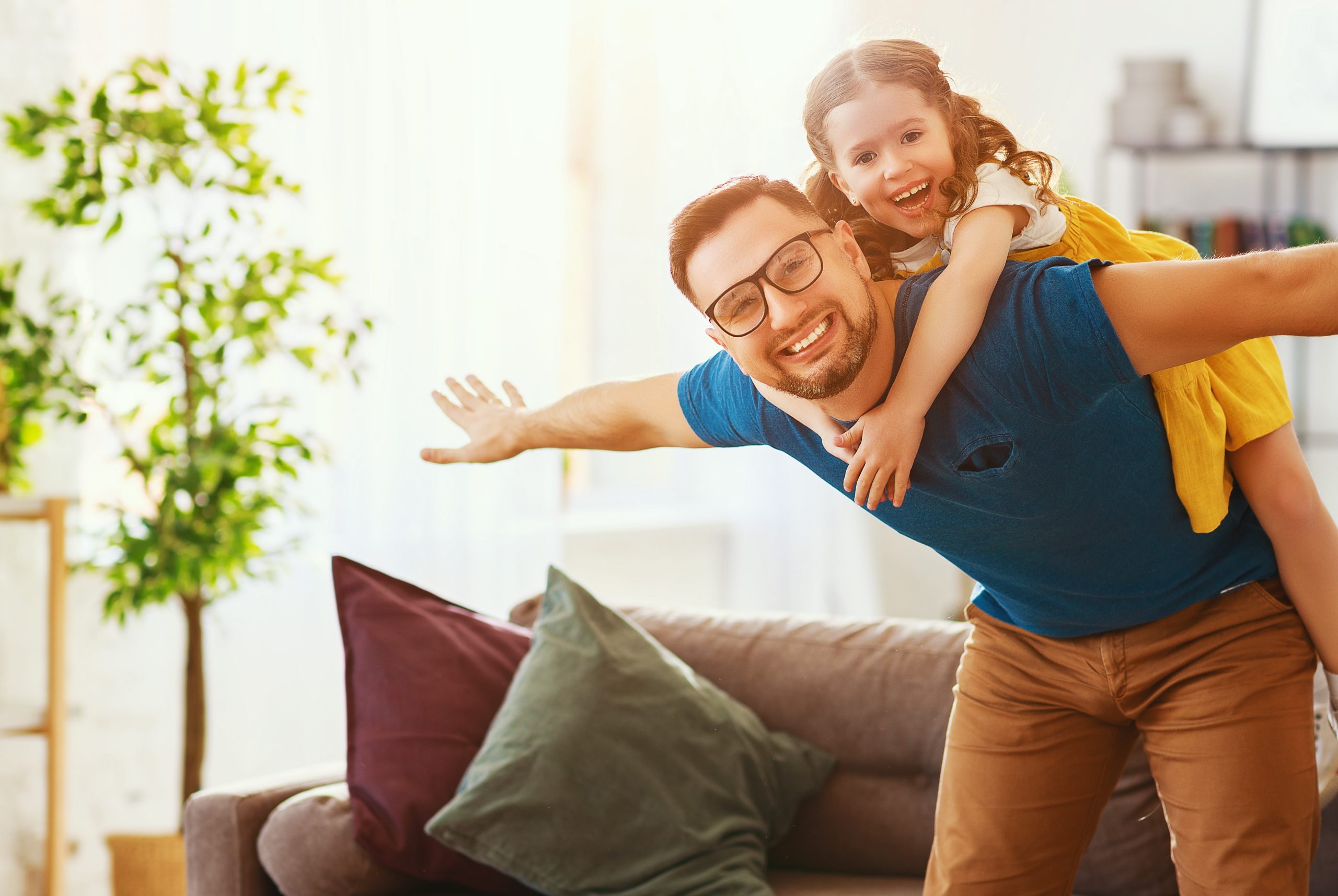 A man and his daughter are posing for the camera.