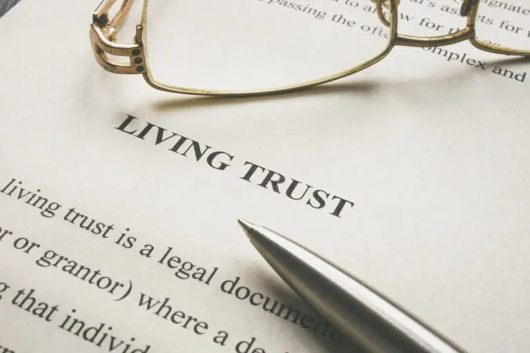 A pen and glasses on top of a living trust document.